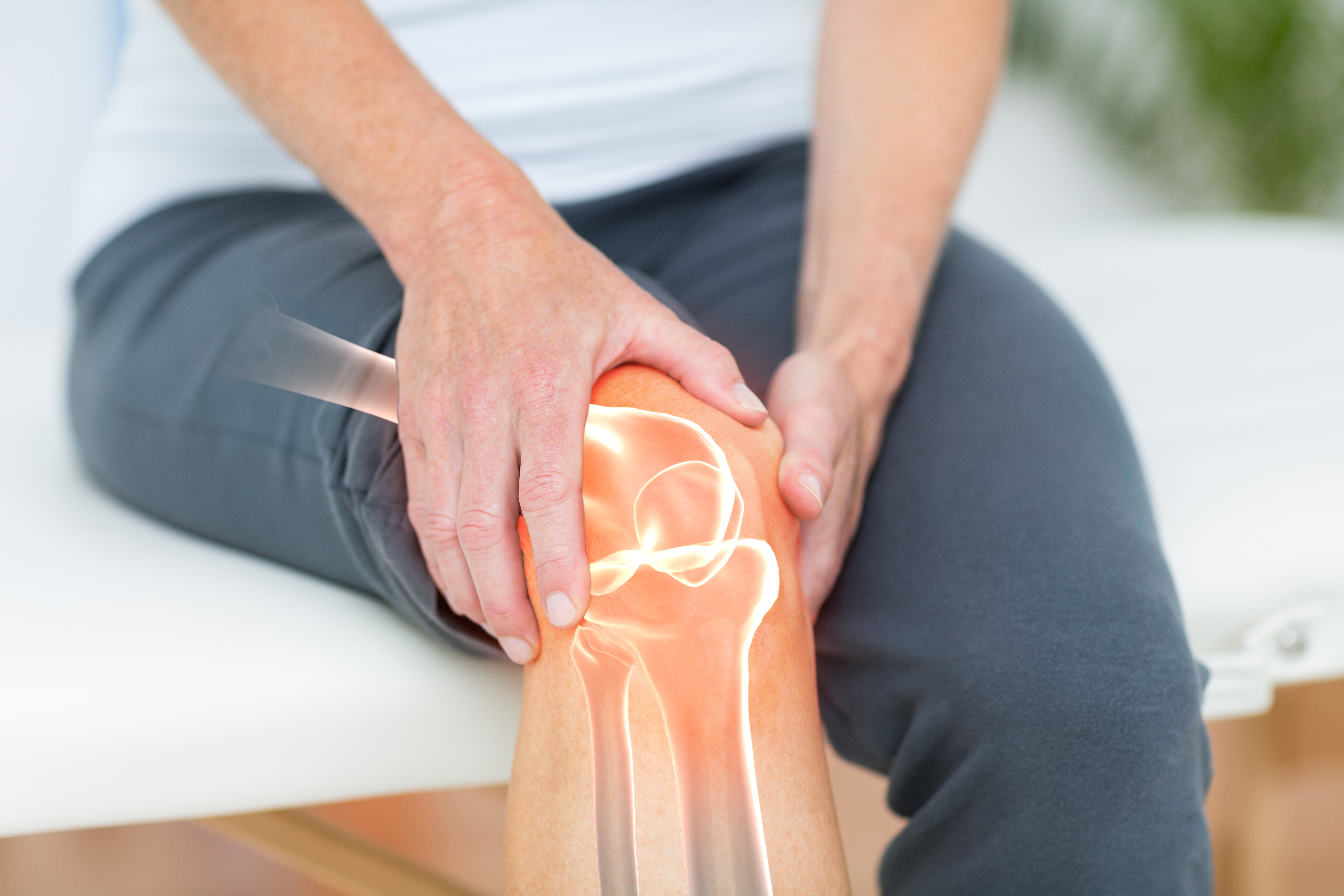 Image of white man holding knee with internal image of knee joint