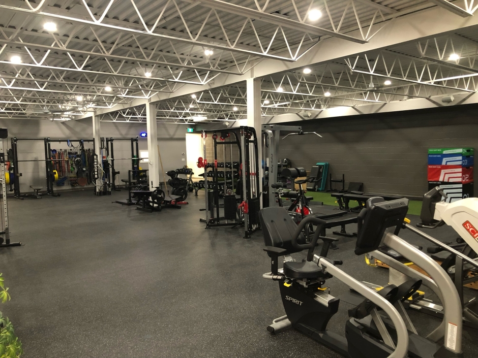 View of the gym showing some of the cardio equipment, weights, turf track.