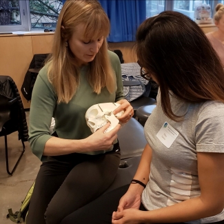 Maria Zerjav teaching a student using a model skull